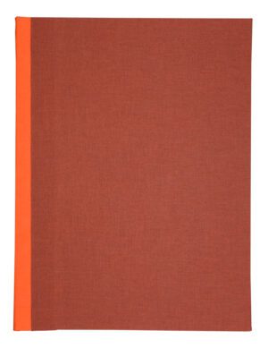 A red book with orange edges on top of it.