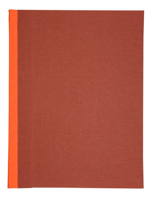 A red book with orange edges on top of it.