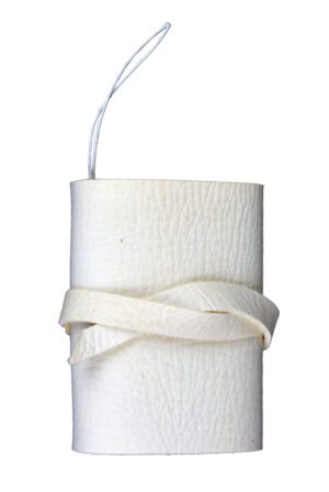 A white candle with a ribbon around it.