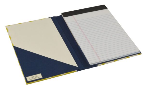 A notebook with a blue cover and a white paper.