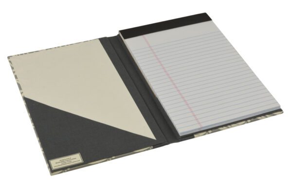 A black and white notebook with a note pad