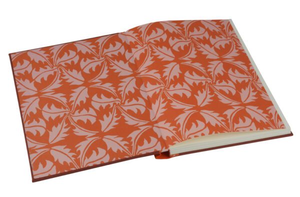 A book with an orange cover and white leaves.