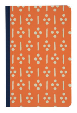 A notebook with an orange cover and white dots.