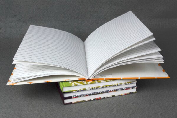 Stack of lined notebooks with colorful covers.