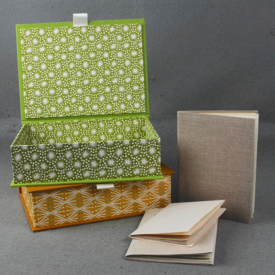 Green and gold patterned box with books.