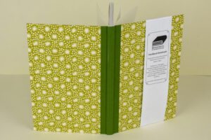 Green floral-patterned hardback notebook.