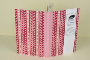 Pink floral patterned hardback notebook.
