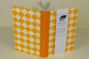 Orange and white patterned hardback notebook.