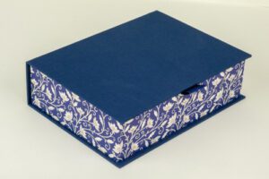 Navy blue box with floral pattern.