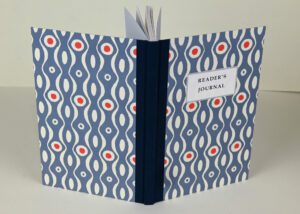 Reader's journal, blue cover, red accents.