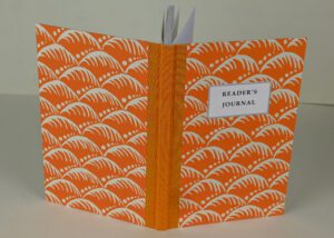 Orange reader's journal with wave pattern.