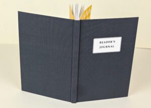 Dark gray reader's journal with gold pages.