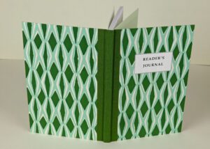 Green reader's journal with geometric pattern.