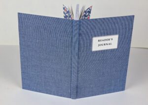 Blue reader's journal with patterned bookmark.