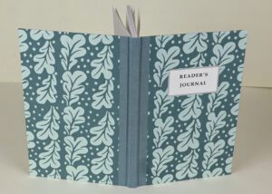 Teal reader's journal with leaf print.