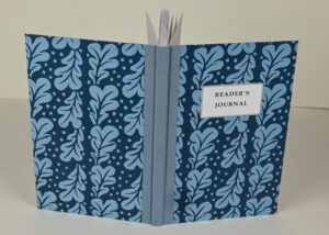 Blue reader's journal with leaf pattern.