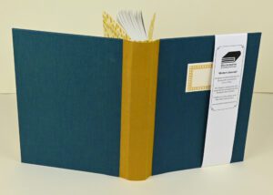 Teal writer's journal with gold spine.