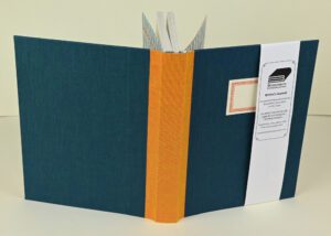 Teal writer's journal with orange spine.