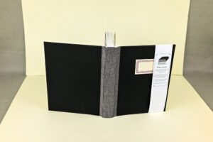 Black writer's journal with gray spine.