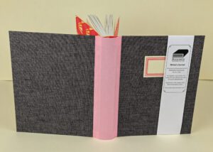 Gray writer's journal with pink spine.