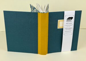 Teal writer's journal with gold spine.